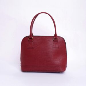 Stylish red leather handbag with handles on a clean white background, perfect for fashion enthusiasts.